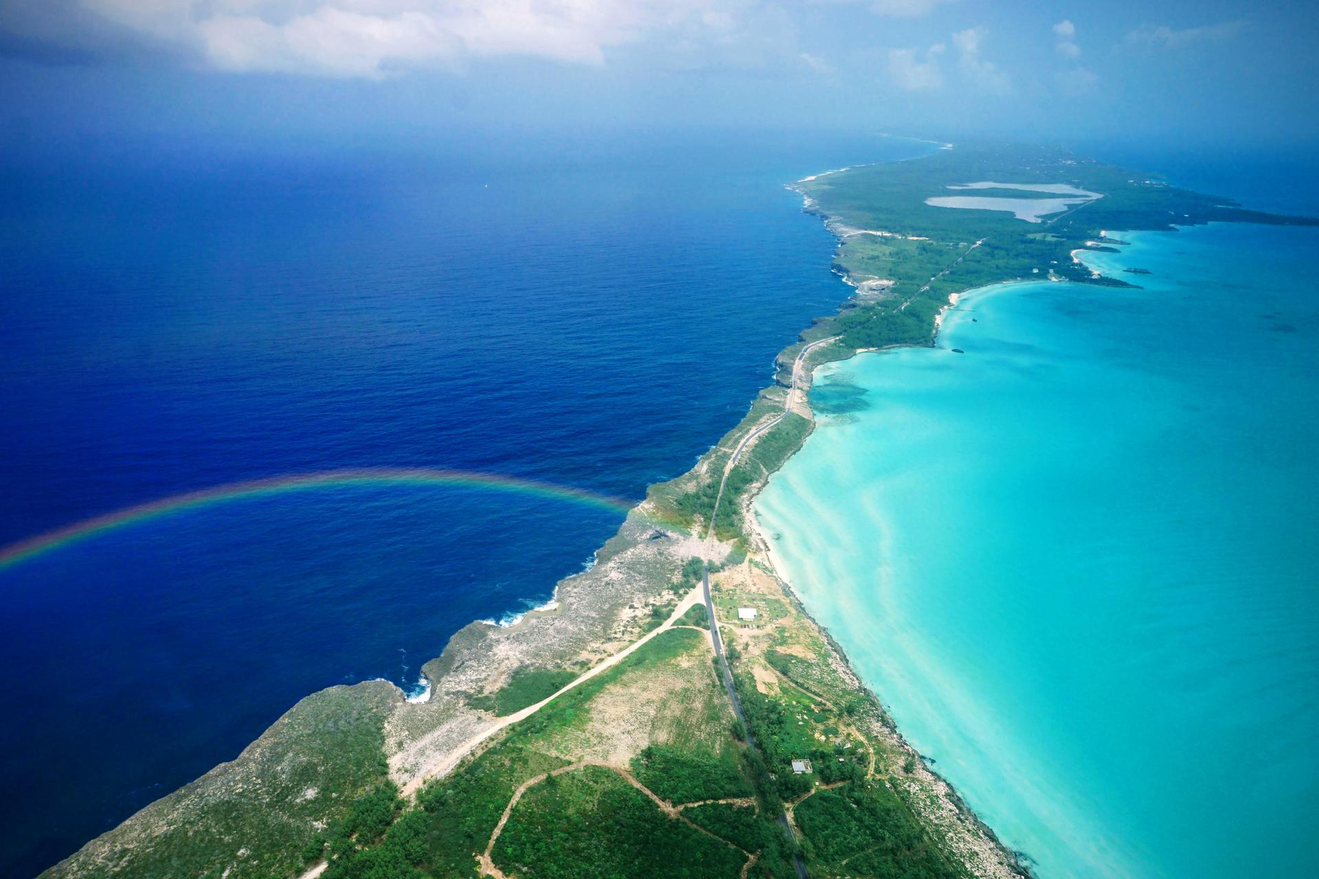Aerial view of Eleuthera's coastline with a rainbow over the Atlantic